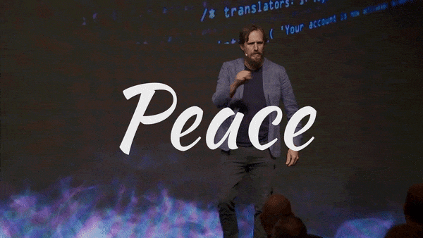 Simon Waller waving a peace sign hand gesture