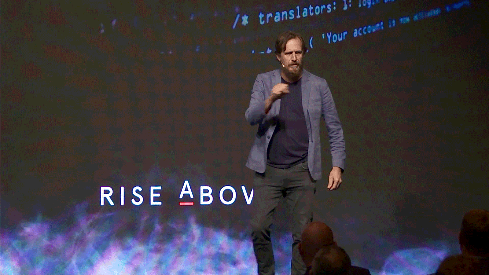 Simon Waller gestures peace sign on stage